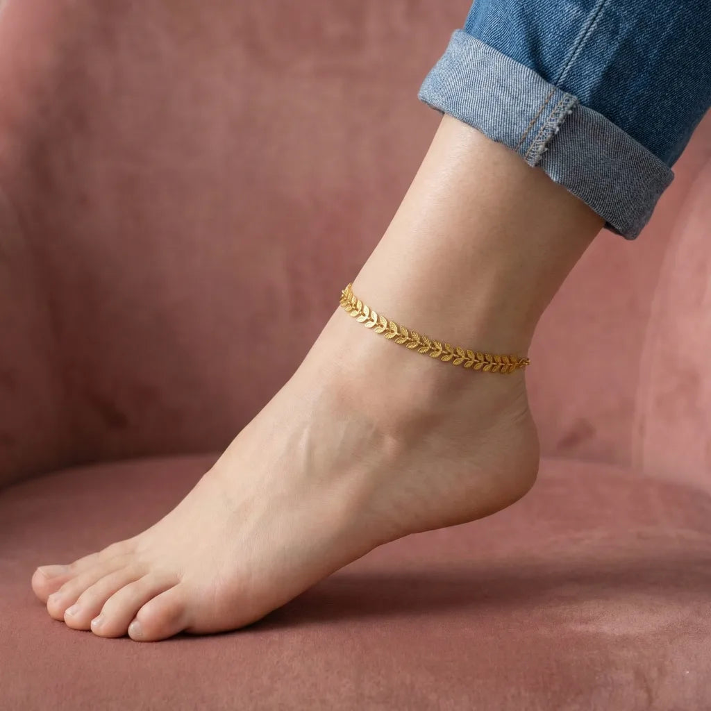 Gold anklet on a foot with a blurred background
