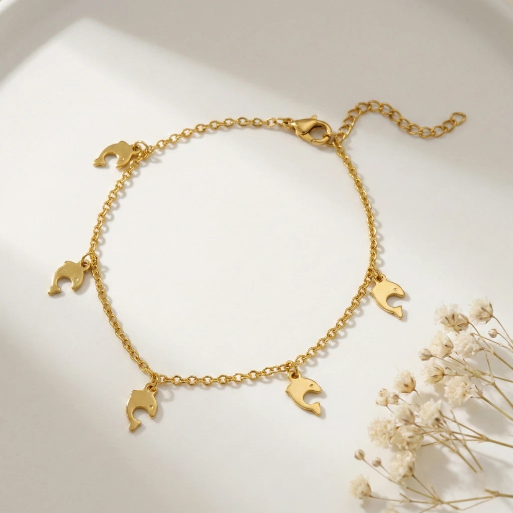 Gold bracelet with moon-shaped charms on a light background