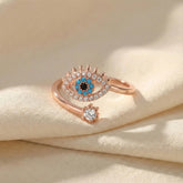 Rose gold ring with gemstones on a beige fabric background