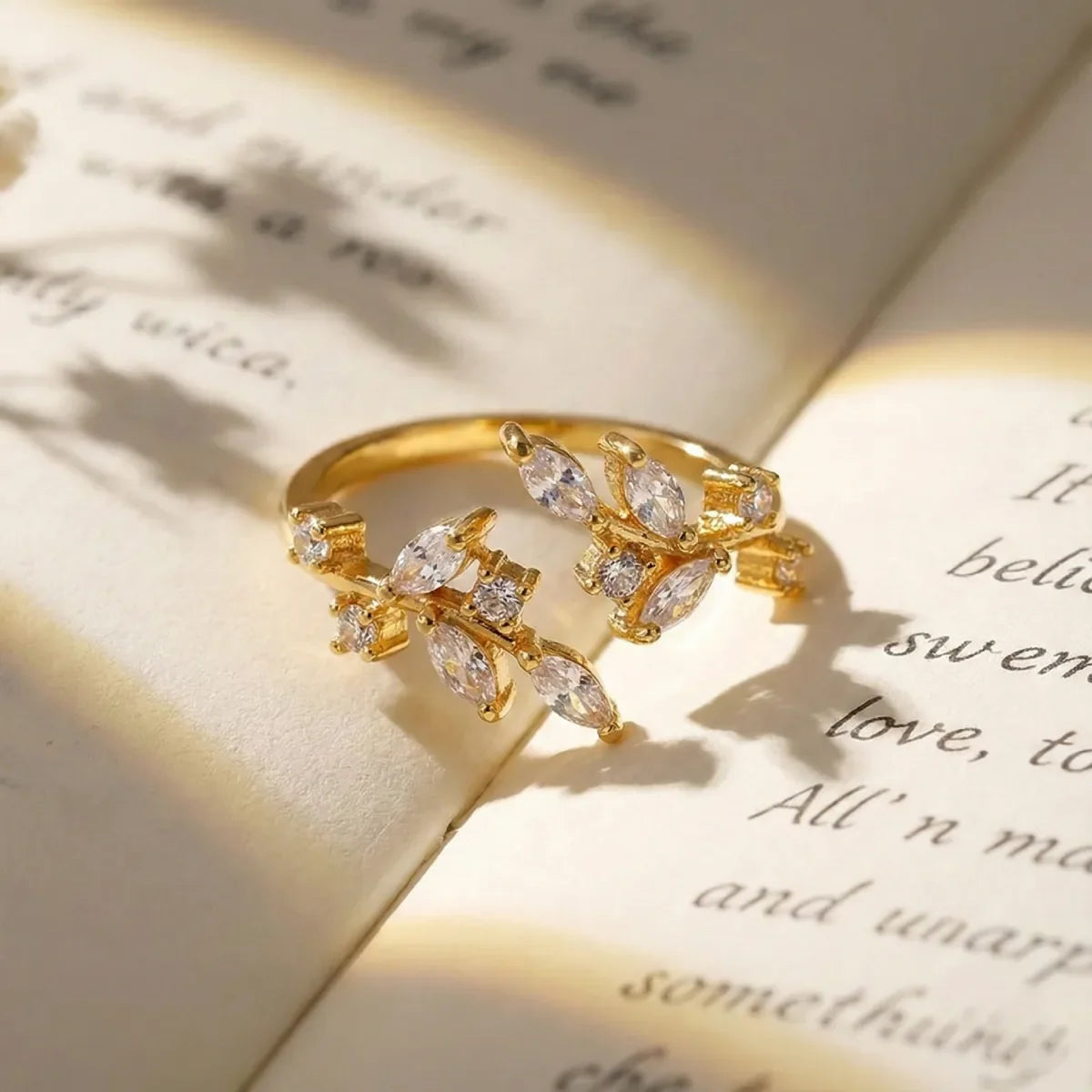 Gold ring with diamonds on an open book