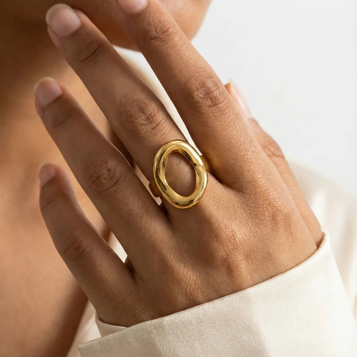 Geometric oval statement golden ring worn on hand