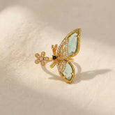 Golden butterfly statement ring with green enamel wings