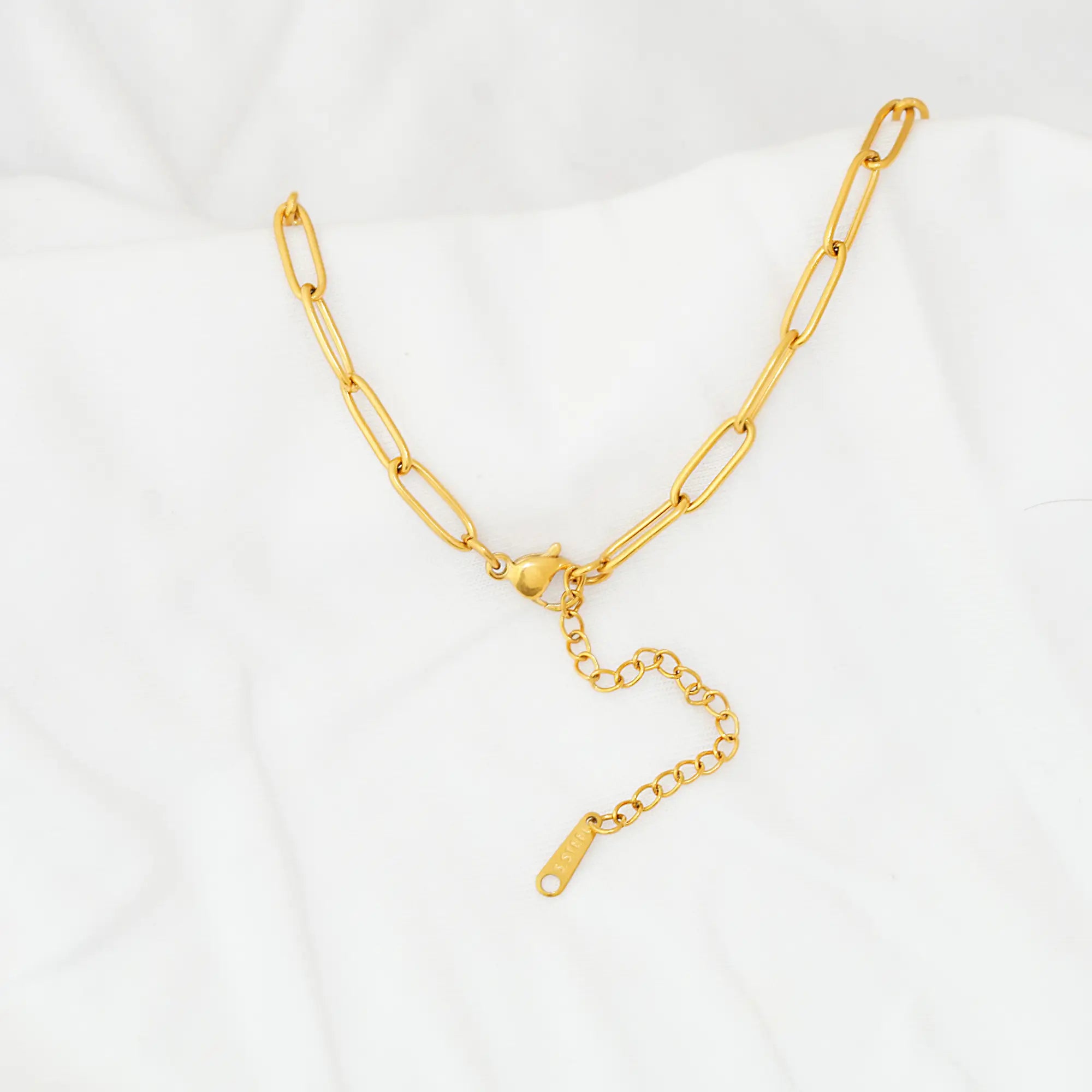 Gold chain closer necklace on a white background