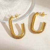 Geometric golden chain hoop earrings close-up