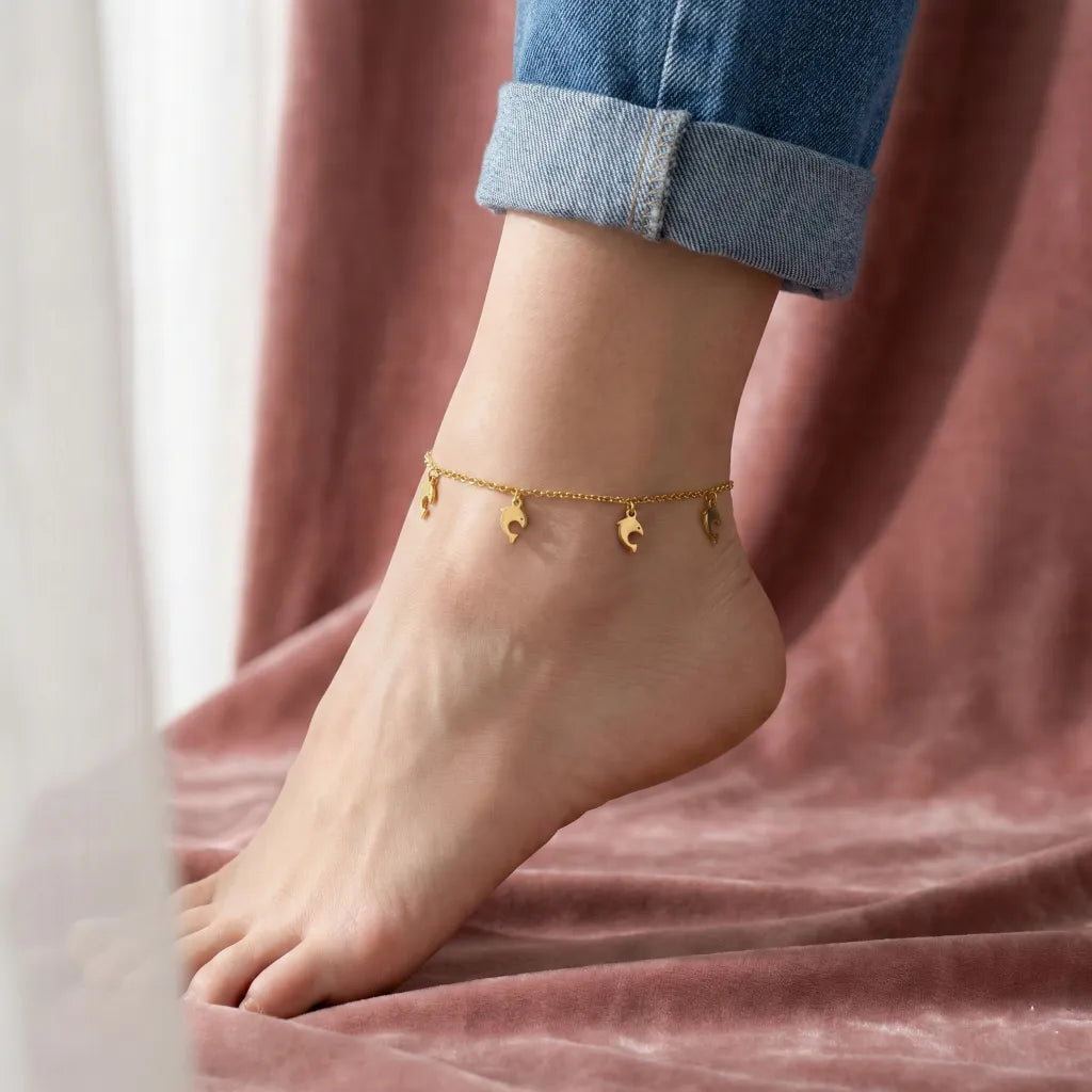 Gold anklet on a foot with a blurred background