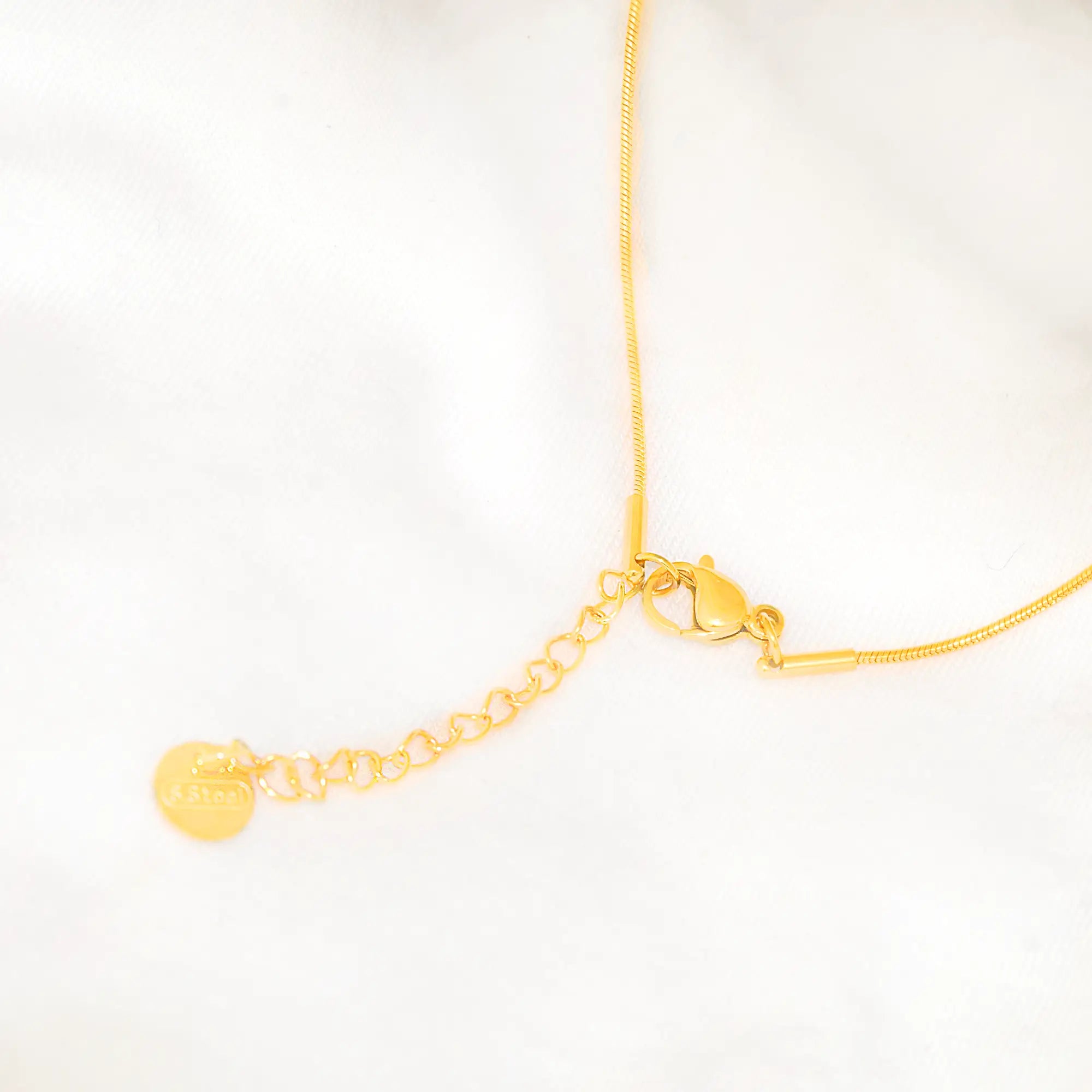 Gold necklace on a white background