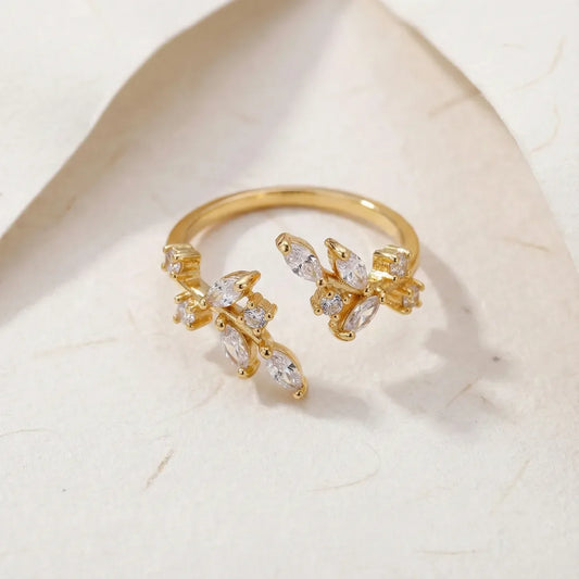 Gold ring with diamond accents on a light marble background 1200
