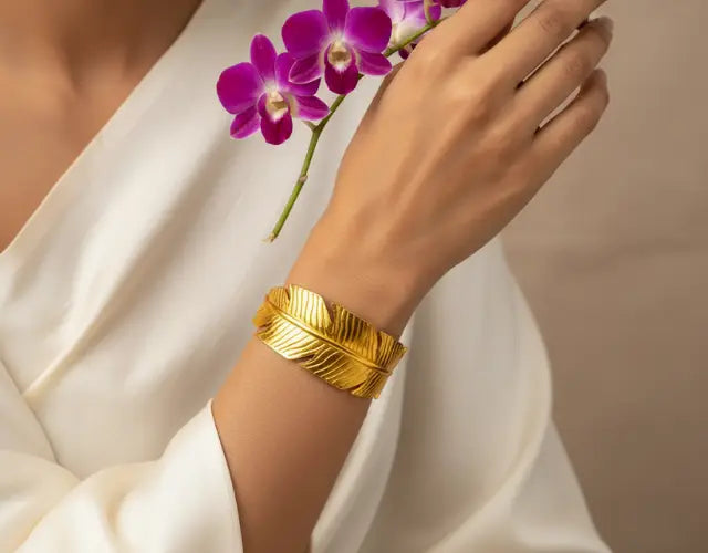 Gold bracelet on a wrist with a blurred background