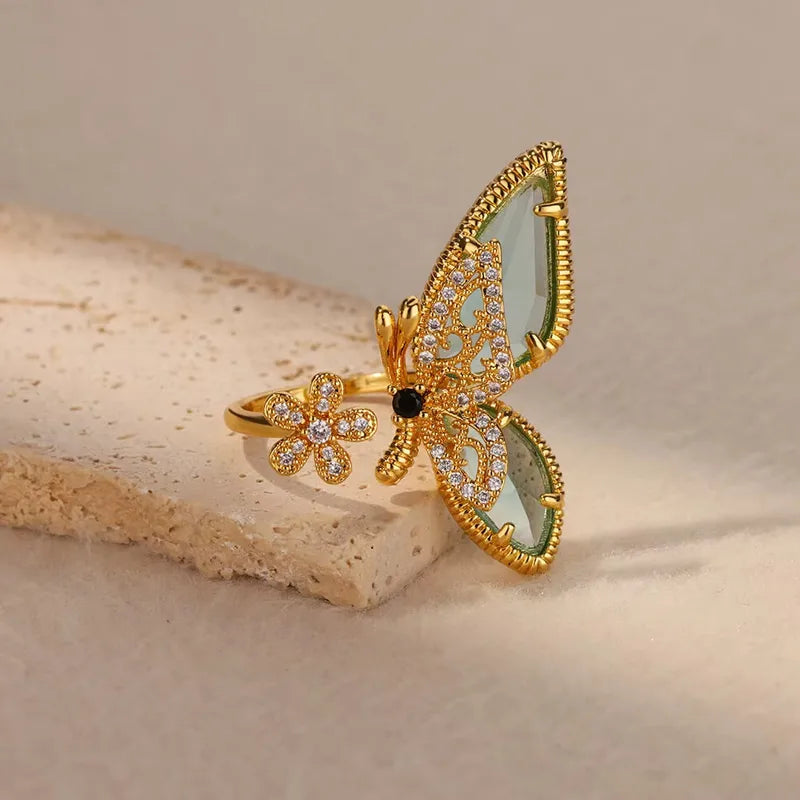 Golden butterfly statement ring styled on stone