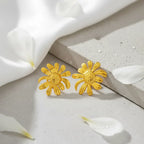 MoodStanBohoFlowerGoldEarringStudwhiteclothandconcreteslab