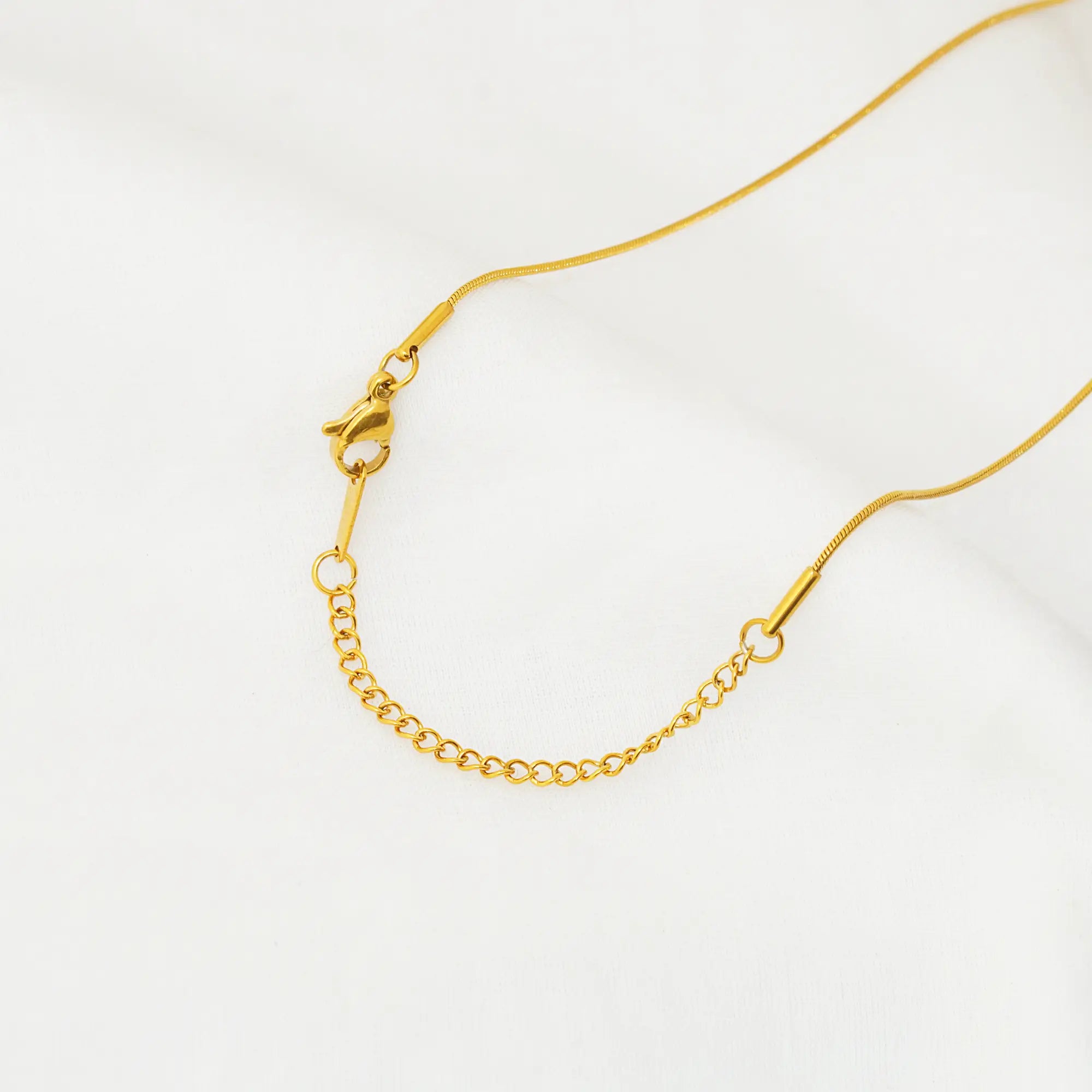 Gold chain necklace on a white background