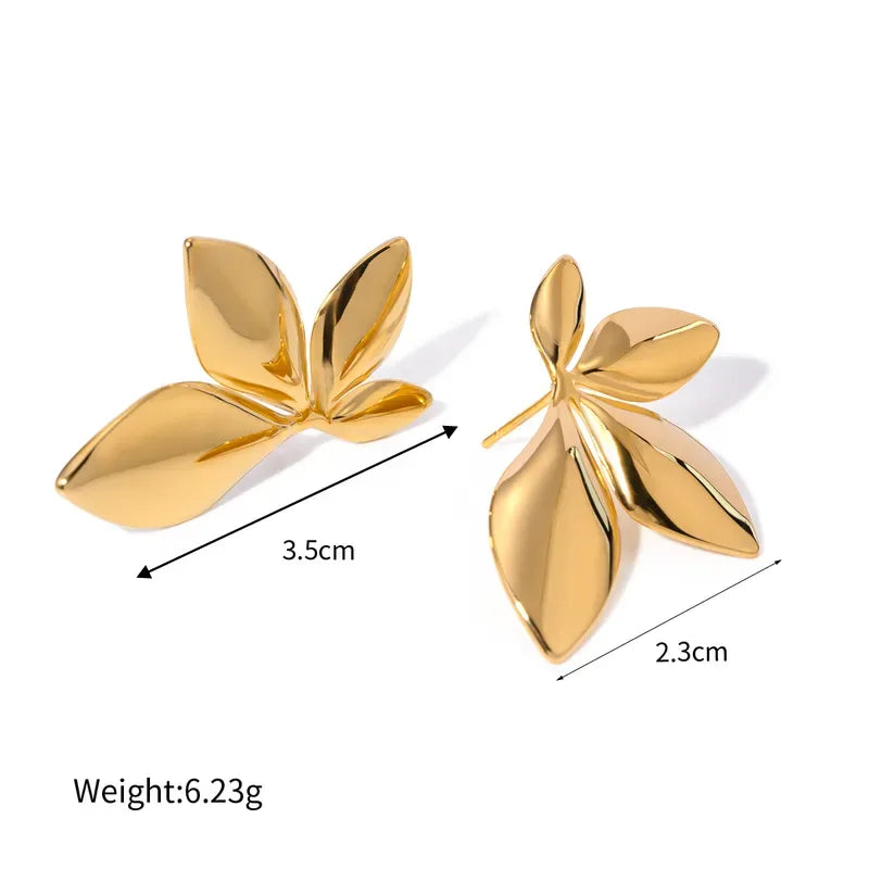 Gold leaf-shaped earrings with measurements and weight on a white background