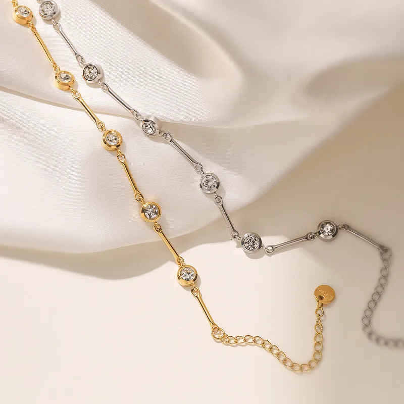 Gold and silver beaded necklace on a soft beige background