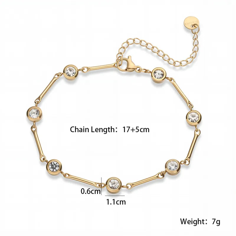 Gold bracelet with crystal stones and measurements on a white background