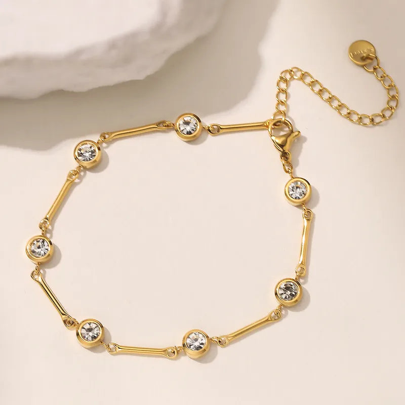 Gold bracelet with crystal stones on a beige background
