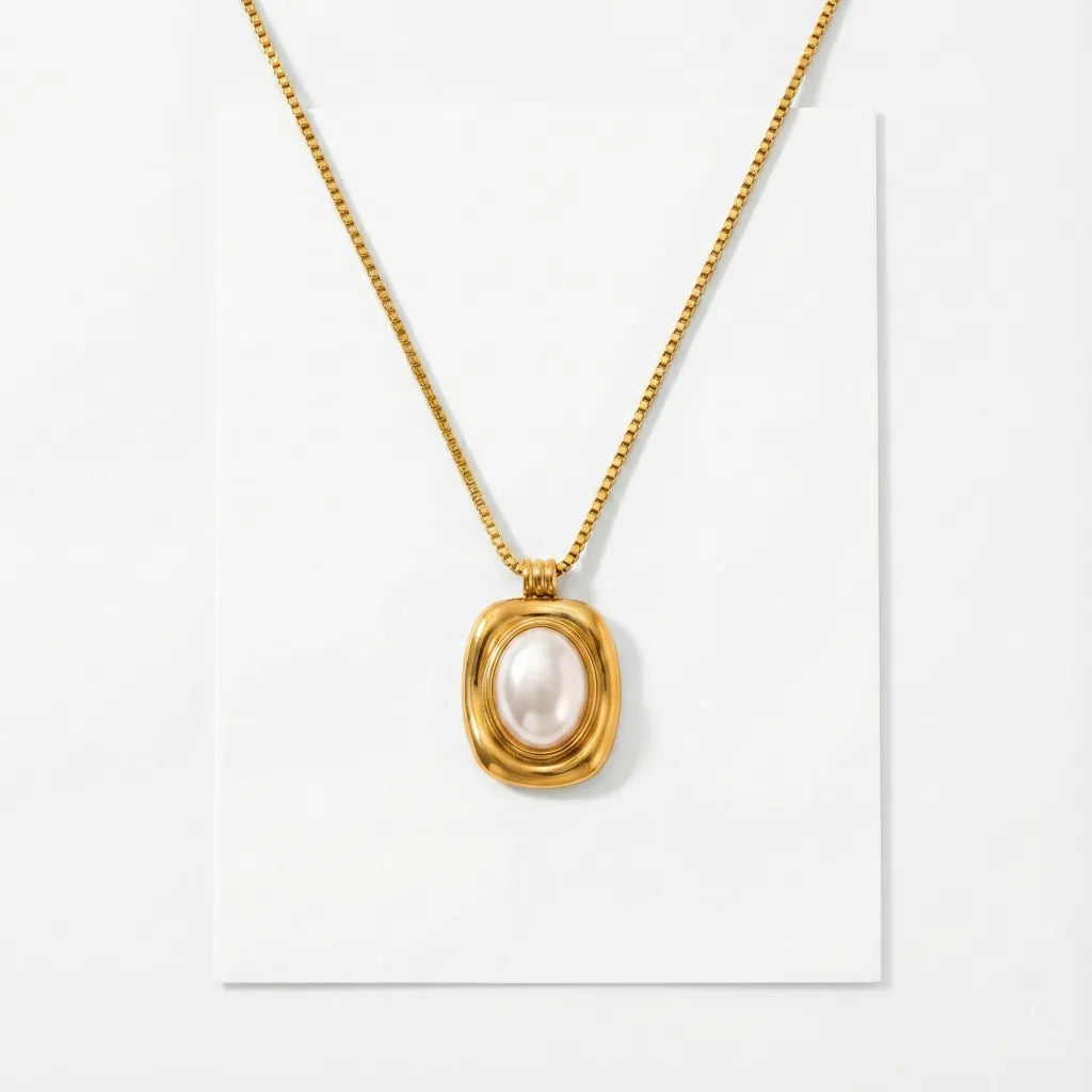 Gold necklace with a pendant on a white background